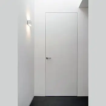 White wooden flush to drywall trimless interior door