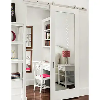 White wooden interior full length mirrored barn door for closet